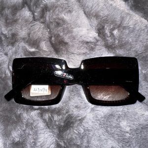 Women’s sunglasses. Oversized square shape, black with rhinestones.